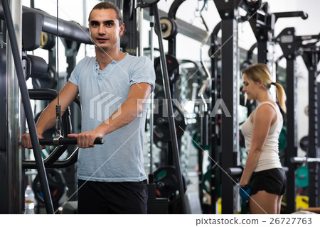 Adults having strength training under coach control in gym Adults having strength training under coach control in gym 26727763