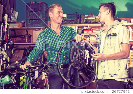 Man and teenage boy choosing new wheel Man and teenage boy choosing new wheel 26727941