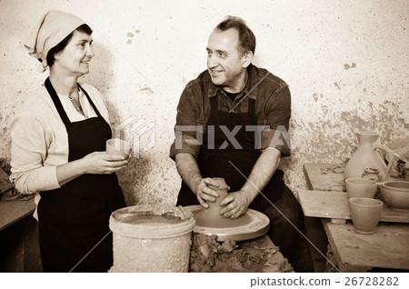 Two potters in the process of work at the workshop Two potters in the process of work at the workshop 26728282