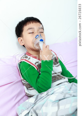 Closeup of asian child holds a mask vapor inhaler. Closeup of asian child holds a mask vapor inhaler. 26728833