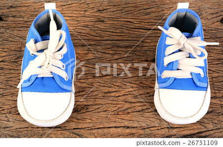 Baby sneakers on wood background 26731109