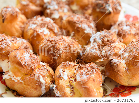 Profiteroles with cream and chocolate shavings 26731763