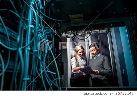 Young engineers businessmen in server room Young engineers businessmen in server room 26732145