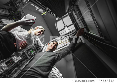 Young engineers businessmen in server room Young engineers businessmen in server room 26732148