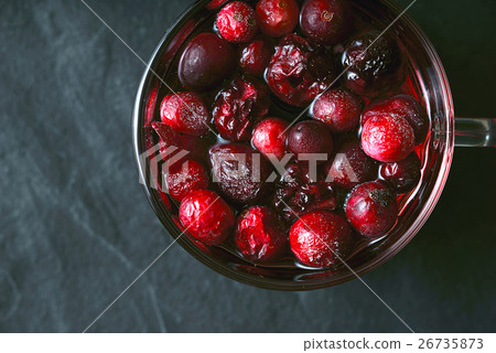 Cup of tea with berries on the dark stone table Cup of tea with berries on the dark stone table 26735873