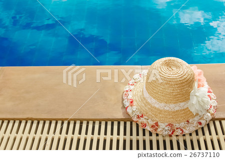 Straw hat be side of swimming pool. happy vacation Straw hat be side of swimming pool. happy vacation 26737110