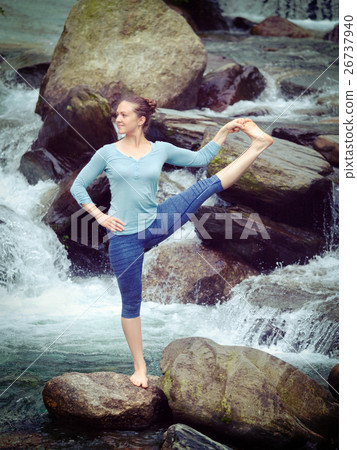 Woman doing Ashtanga Vinyasa Yoga asana outdoors 26737940