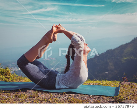 woman doing Ashtanga Vinyasa Yoga asana 26737979