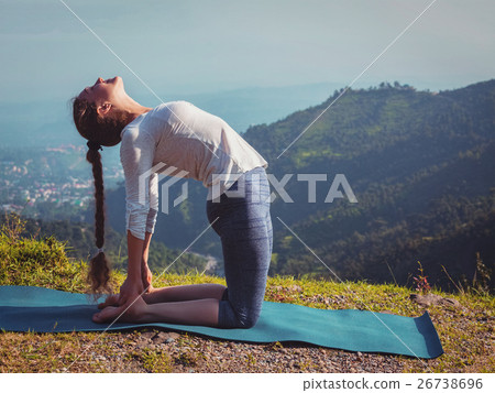 Woman doing yoga asana Ustrasana camel pose Woman doing yoga asana Ustrasana camel pose 26738696