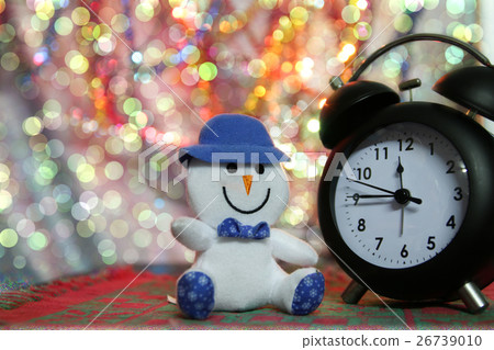 Snow man and retro clock with bokeh background 26739010