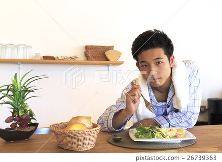 Facial expression of young man in pajamas variations: breakfast Facial expression of young man in pajamas variations: breakfast 26739363