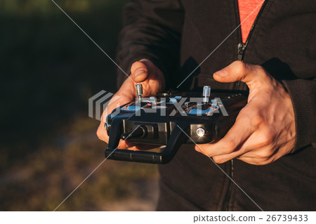 Man holding remote controller in hands close-up 26739433