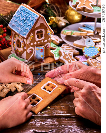 Grandmother and granddaughter make gingerbread Grandmother and granddaughter make gingerbread 26739786