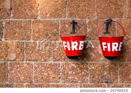Red fire bin on brick wall background Red fire bin on brick wall background 26740928