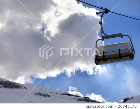 Chair-lift in ski resort and blue sky with clouds  26743176