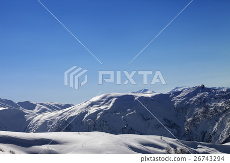 Off-piste slope and blue clear sky in sun morning Off-piste slope and blue clear sky in sun morning 26743294