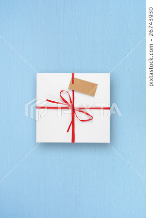 White gift box with blank tag on blue table 26743930