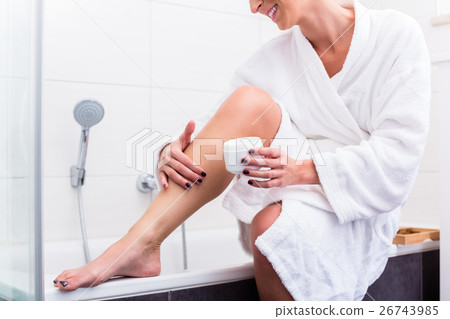 Woman sitting at edge of bathtub  26743985