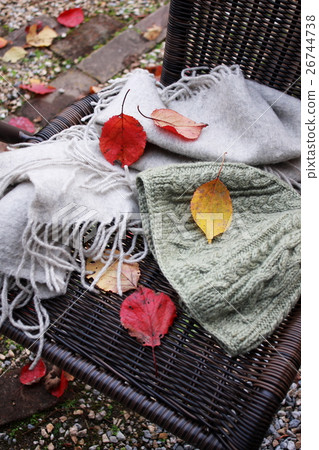 Hat and muffler on garden chair 26744738