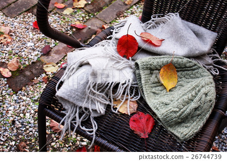 Hat and muffler on garden chair 26744739