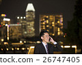Asian businessman using smart phone in city at night. 26747405