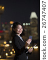 Asian businesswoman using her smart phone in city at night. 26747407