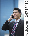 Chinese business man talking on a mobile phone 26747410