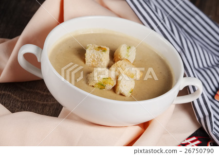 Creme soup with mushrooms in white bowl 26750790