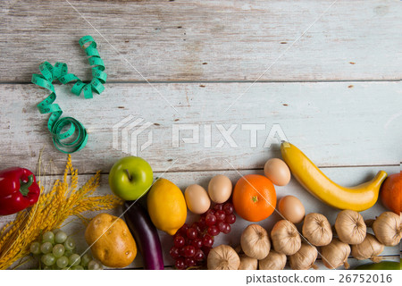 Measuring tape on fruits. Symbol of diet. 26752016