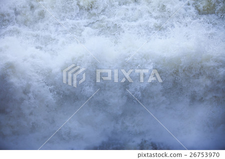 Water flowing from the open sluice gates of dam. 26753970