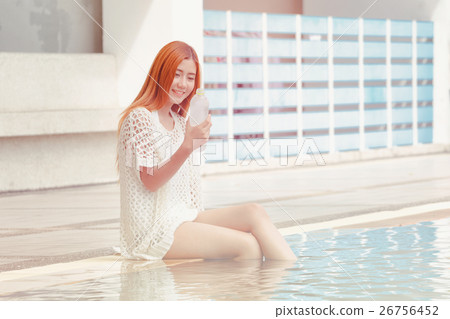 Young Asian woman sitting chill out at  pool  26756452