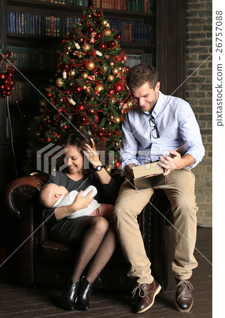 Young family in living room on Christmas night 26757088