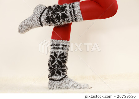 Woman legs wearing woolen socks and red tights 26759550