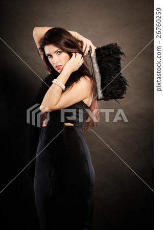 woman evening dress handbag in hand on black 26760259