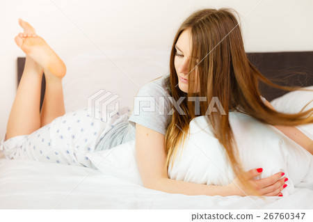 Cheerful girl rolling in bed. Cheerful girl rolling in bed. 26760347
