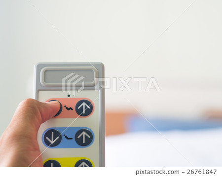 Men hold the Remote control of patient bed . 26761847