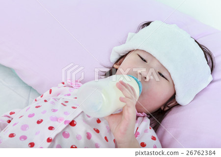 Asian girl with cold and flu suck up milk bottle. Asian girl with cold and flu suck up milk bottle. 26762384