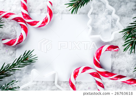 Clear paper laying with candy cane. 26763618