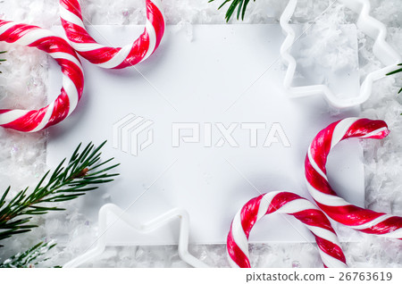 Clear paper laying with candy cane. 26763619