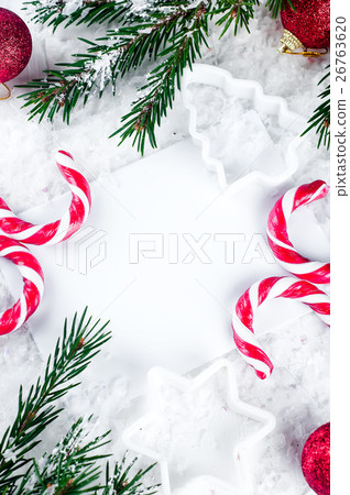 Clear paper laying with candy cane. 26763620