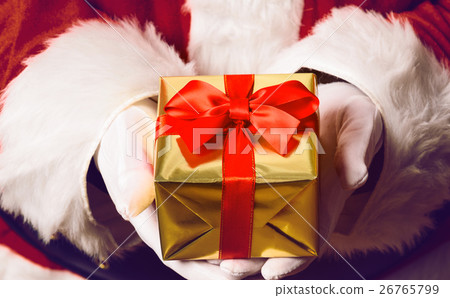 Santa Claus holding gift 26765799