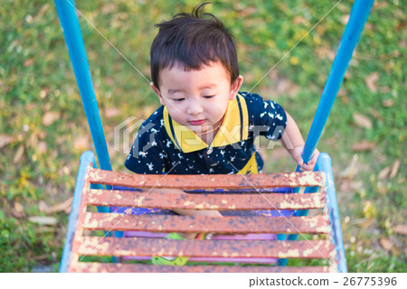 Asian kid goes up the stairs in the park. Asian kid goes up the stairs in the park. 26775396