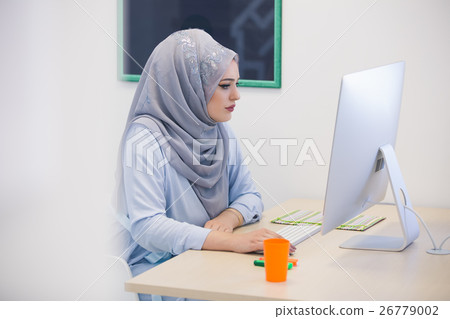 Attractive Muslim young woman working in office on 26779002