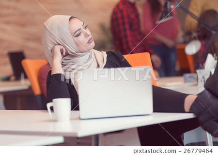 Arabic business woman wearing hijab, working in 26779464