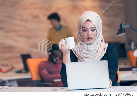 Arabic business woman wearing hijab,working in 26779663