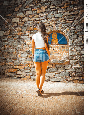 A girl stands near the icon 26779746