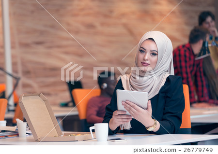 Arabic business woman wearing hijab,working in 26779749