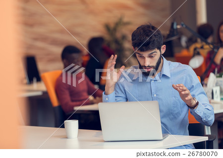 frustrated young business man working on computer frustrated young business man working on computer 26780070
