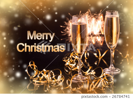 Glasses with champagne against holiday lights Glasses with champagne against holiday lights 26784741