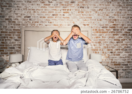 Scared brother and sister in bedroom 26786752